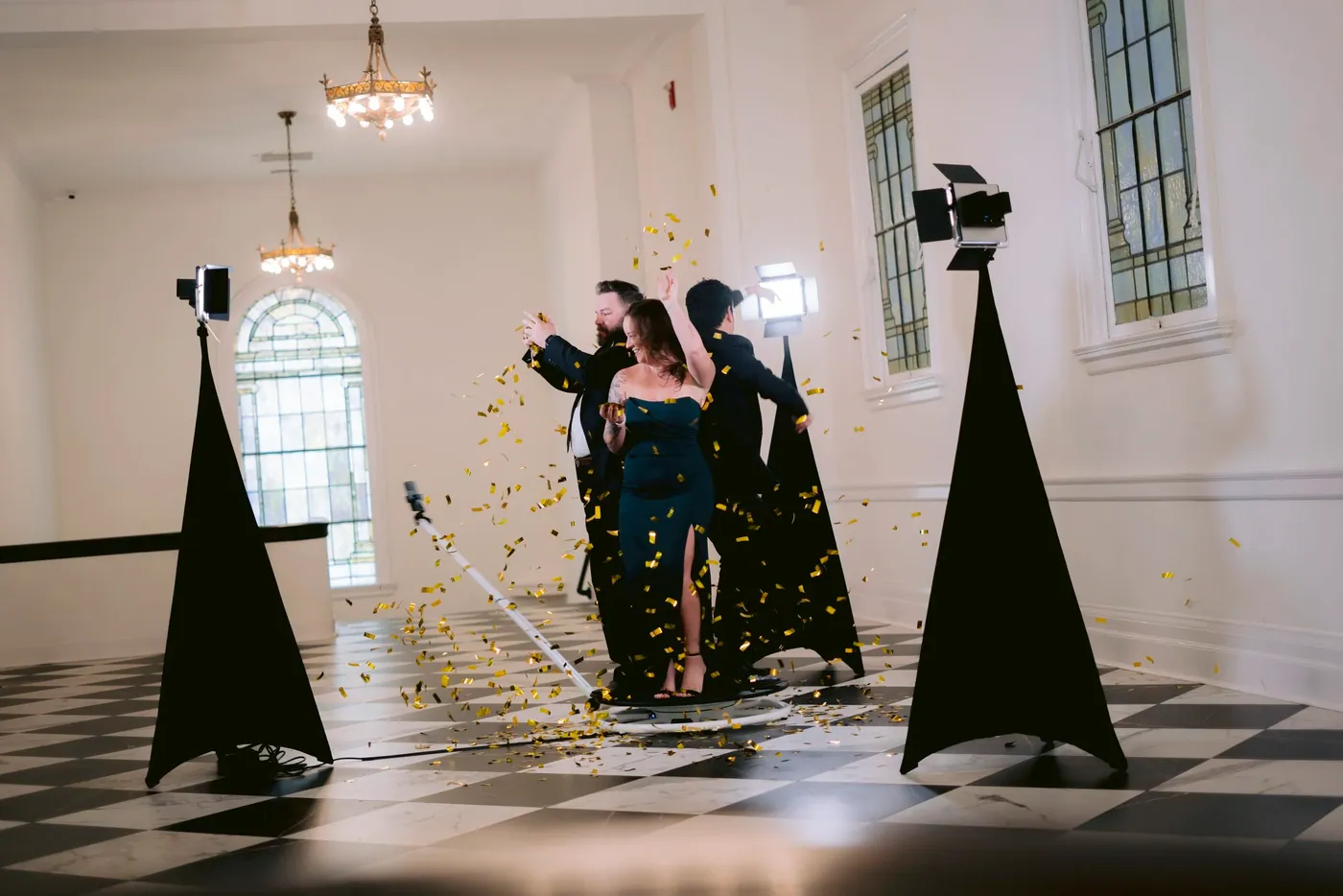 Guests on the 360 platform as gold confetti falls in a ballroom
