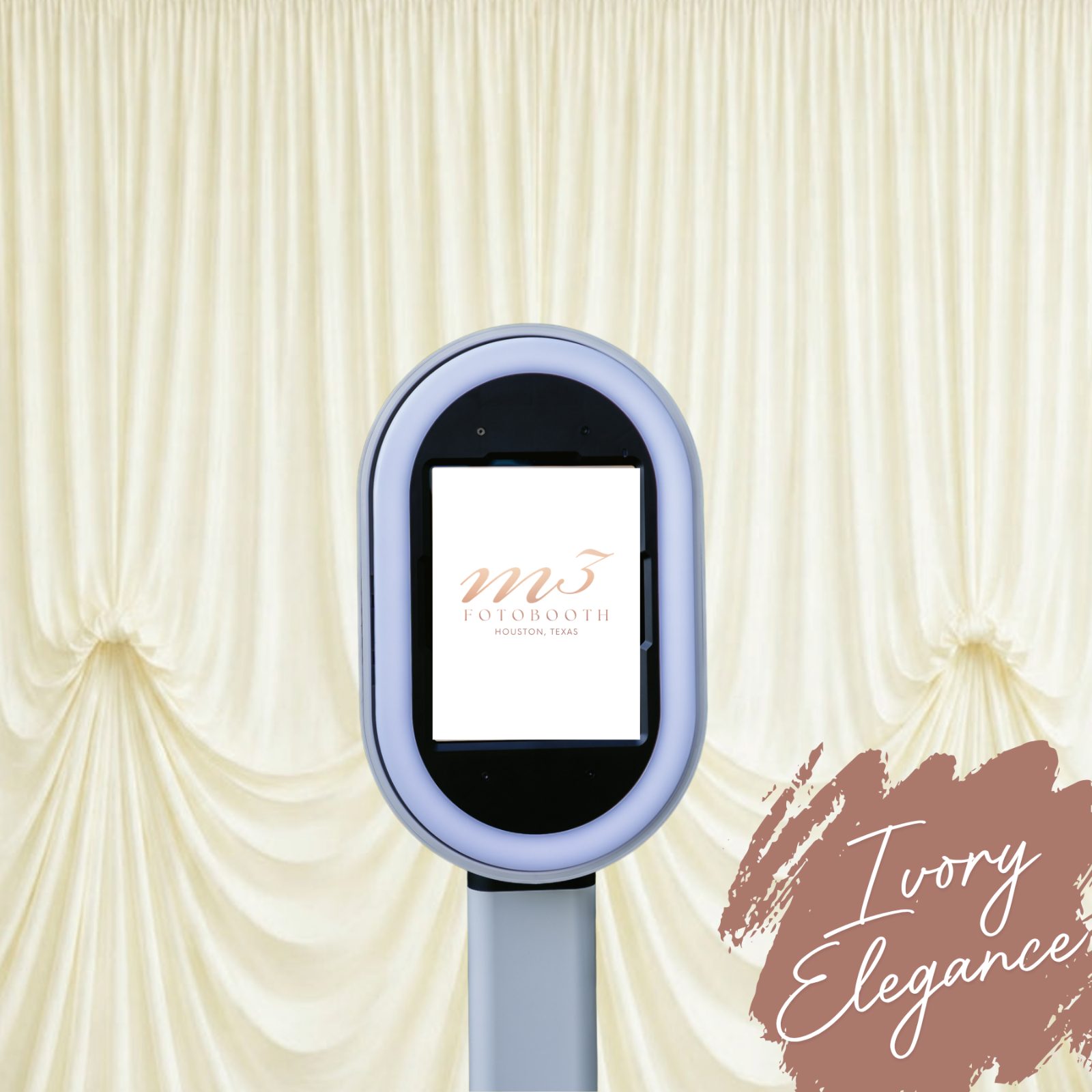 White photo booth showing the M3 Fotobooth logo on screen before an ivory draped backdrop, labeled Ivory Elegance